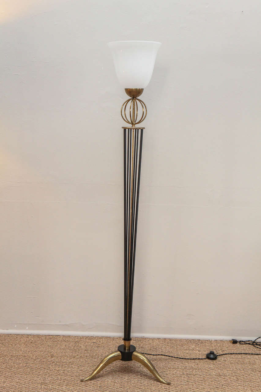 Period French deco floor lamp. Original. Slightly distressed brass finish. All updated hardware and wiring. European style black fabric twist cord with foot switch.