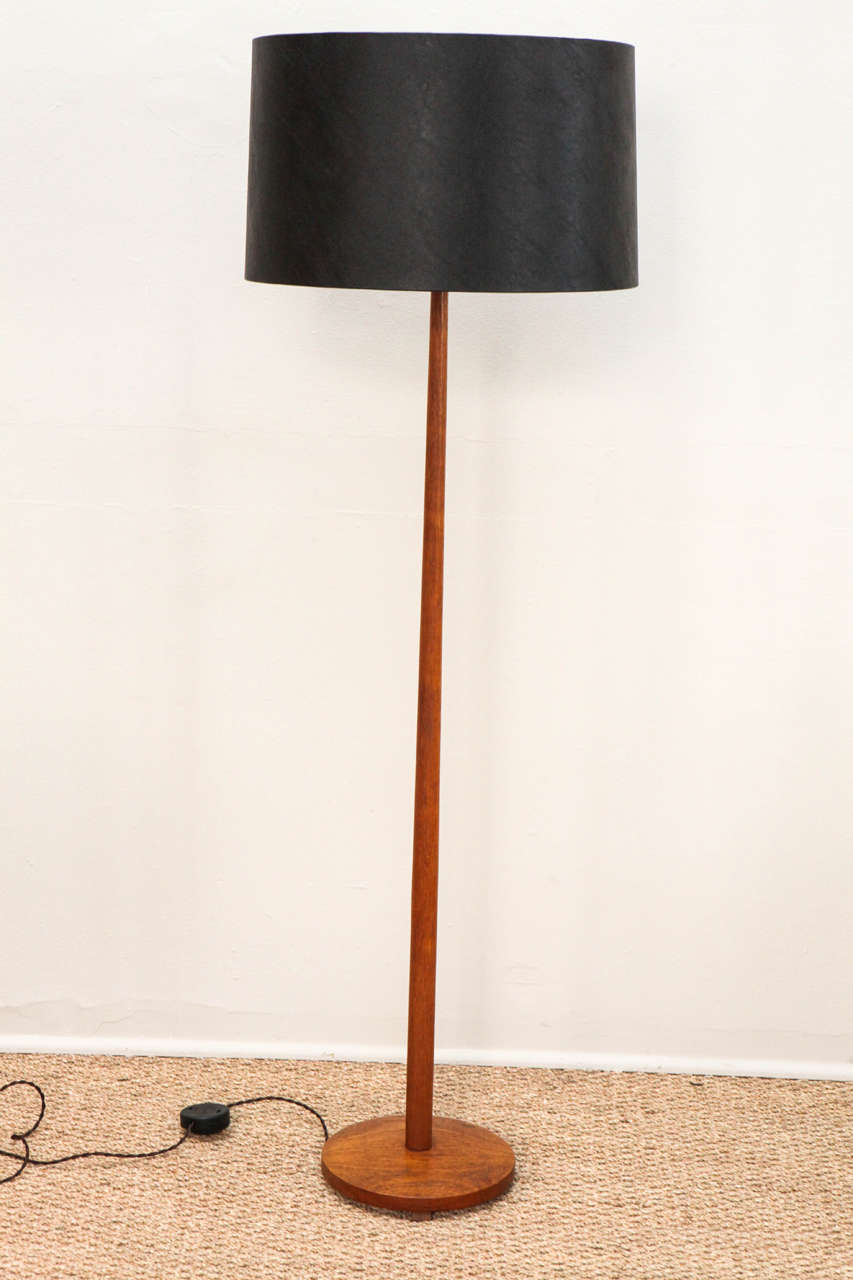 Danish Modern style teak floor lamp.  Updated hardware and wiring.  European style twist cord.  Foot switch on cord.  Custom black leather shade and diffuser.