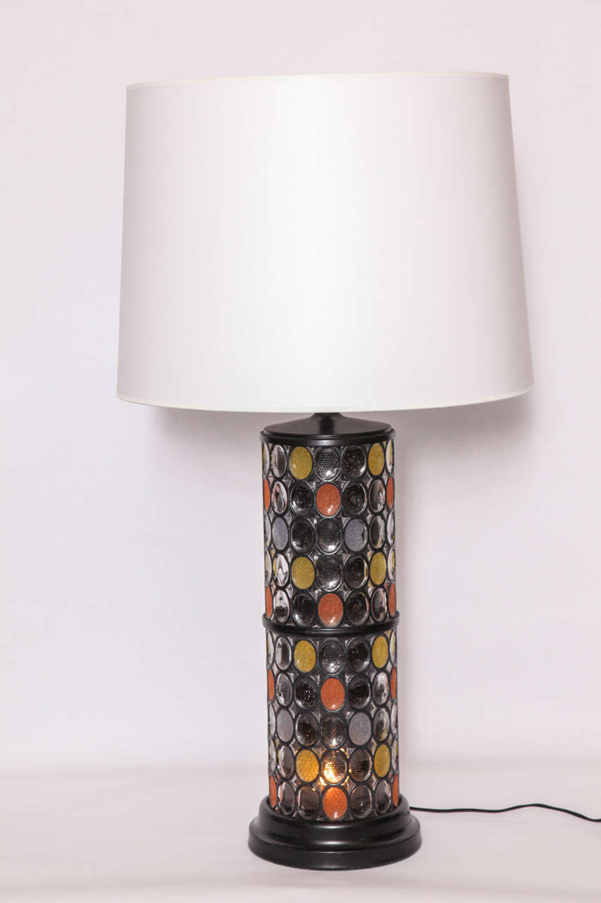 A 1950s modernist table lamp crafted of painted metal and glass.
