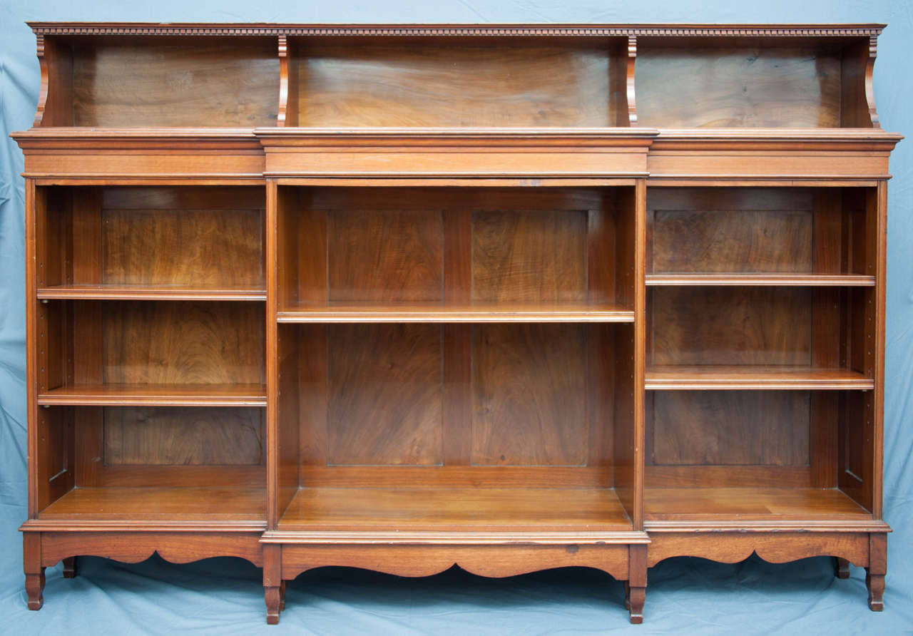 A fine Walnut Bookcase by Morris & Co, designed by George Jack.Of breakfront form, with an upper divided section above an arrangement of open shelves in three sections. Stamped “Morris &Co, 395”
England, circa 1890

126cms H x 183cms w x 38cms
