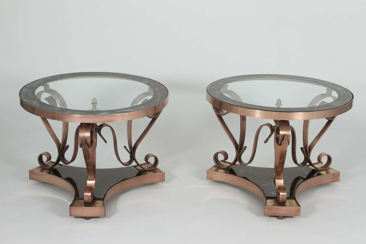 A pair of beautiful, jewel-like side tables by Arturo Pani made in 1950. The brass has a copper colored tone to it and the eglomise glass is original. Exceptional quality and has been maintained and polished with care by original owner.