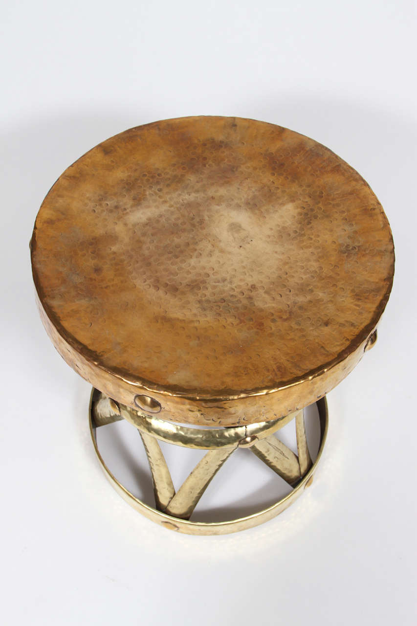 Very chic vintage hammered polished brass strapwork stool or table with X detailing in the Hollywood Regency style. USA, circa 1960.

Seen in the Jerry Lewis/Tony Curtis 1965 movie 