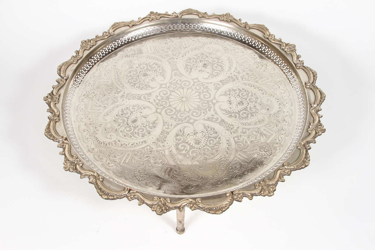 Gorgeous hand chased silver plated large Moroccan serving tray typically used for tea service. Hand chased etching motif and silver finish, the 3 brass legs could be removed and the tray stand flat.George V style. Signed and numbered.