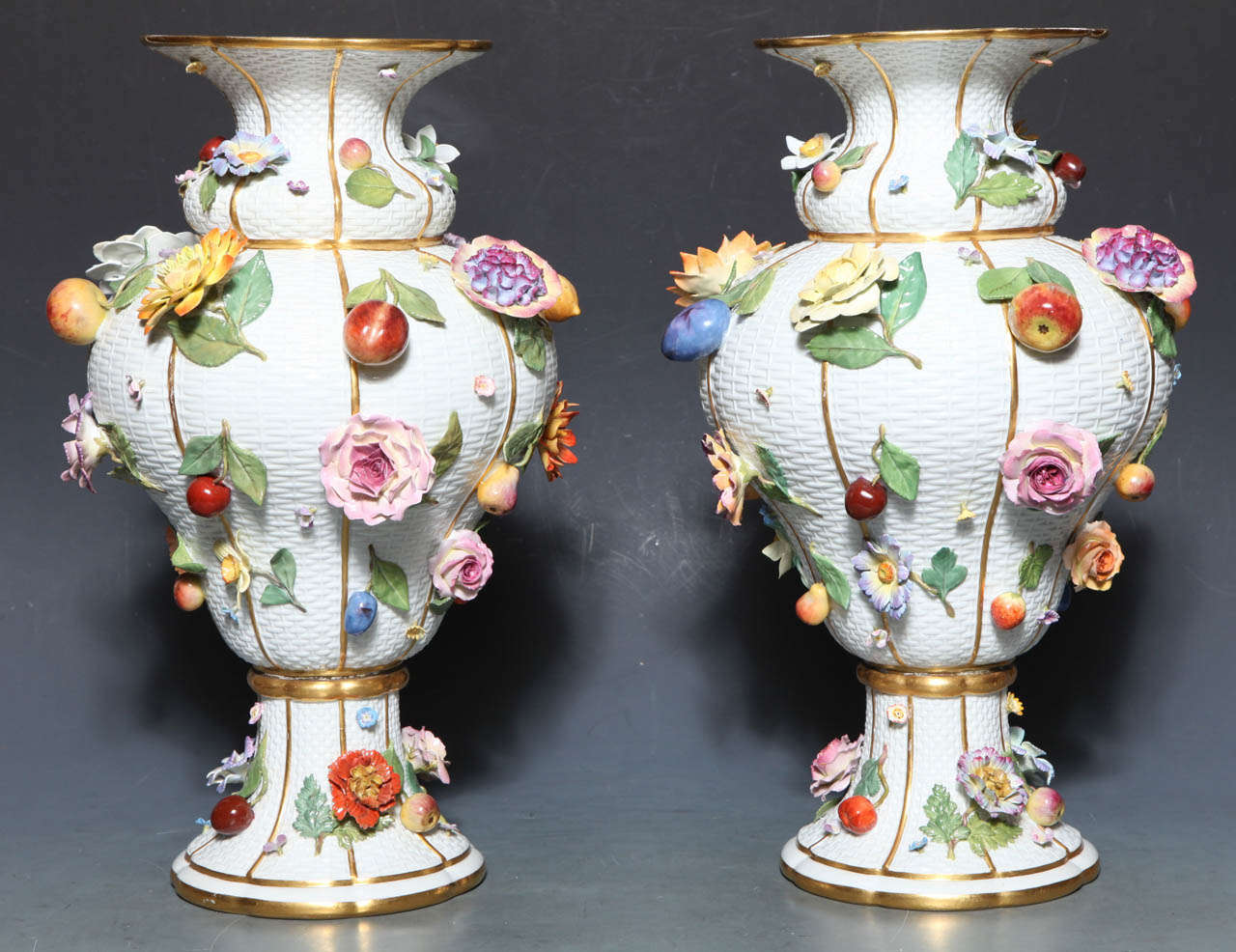 A monumental pair of 19th century Meissen Porcelain vases of exceptional quality. These Vases show one of Meissen's signature motifs, the realistically modeled fruits and flowers (raised on a basket weave background), to great advantage. The apples