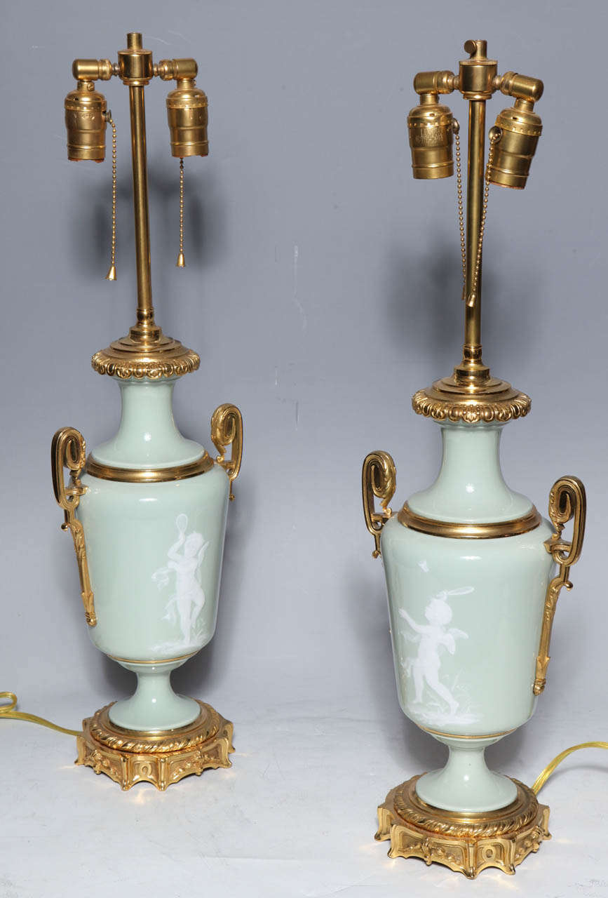 Neoclassical Revival Pair Ormolu Mounted 'Pate sur Pate' Porcelain Lamps Depicting Cupids For Sale