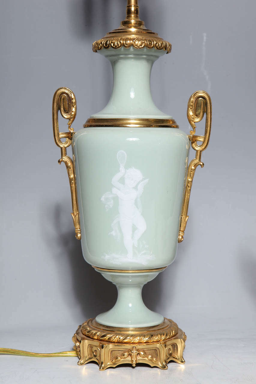 British Pair Ormolu Mounted 'Pate sur Pate' Porcelain Lamps Depicting Cupids For Sale