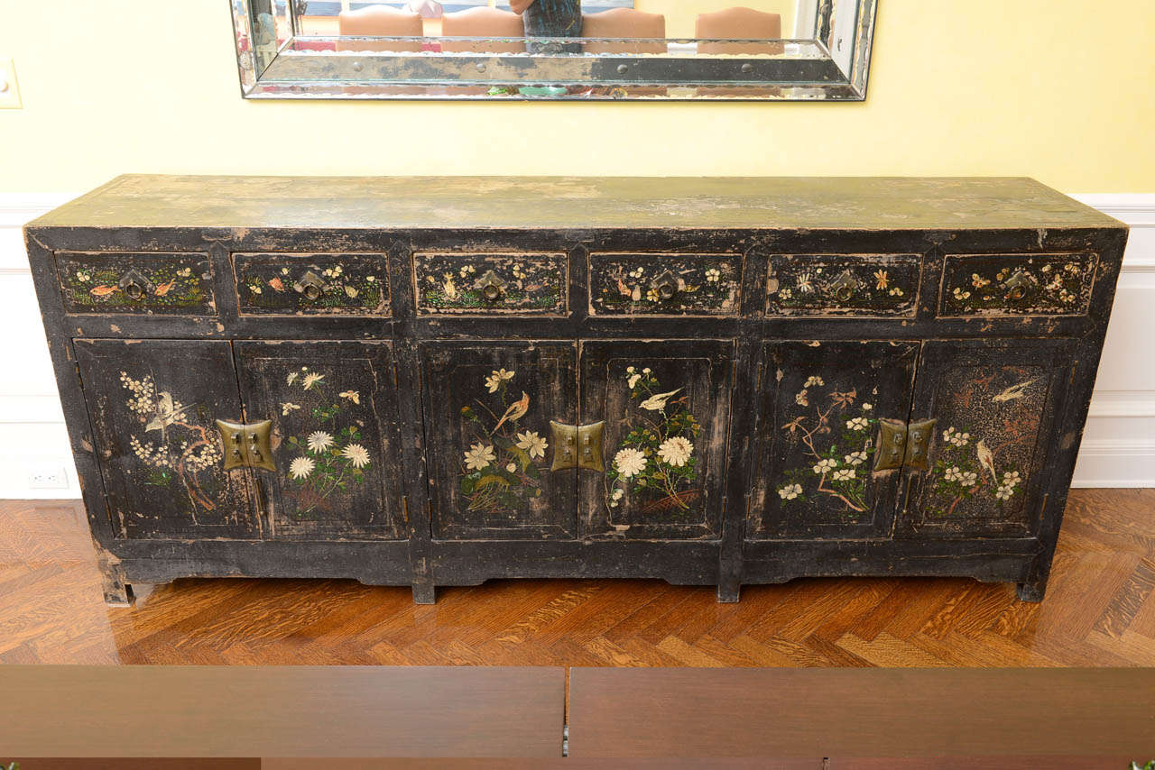 Handpainted with birds and floral sprays, including peonies and lotus blossoms, on a black ground with brass hardware.