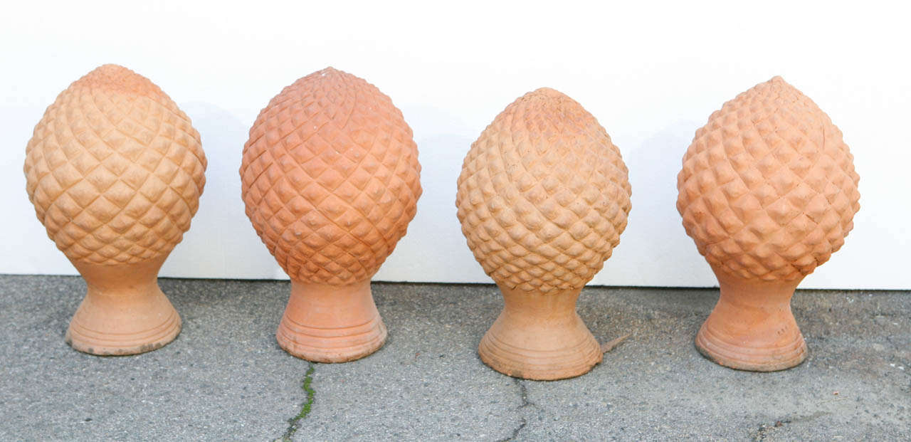 Terracotta  finials for fences, walls or roogs. Cast in swirling pineapple design. Beautiful mossy growth and lovely coloration to the clay.
Sold individually or as a set. $250.00 each or $1000.00 for all four.
From Thailand, ca. 1930. 
