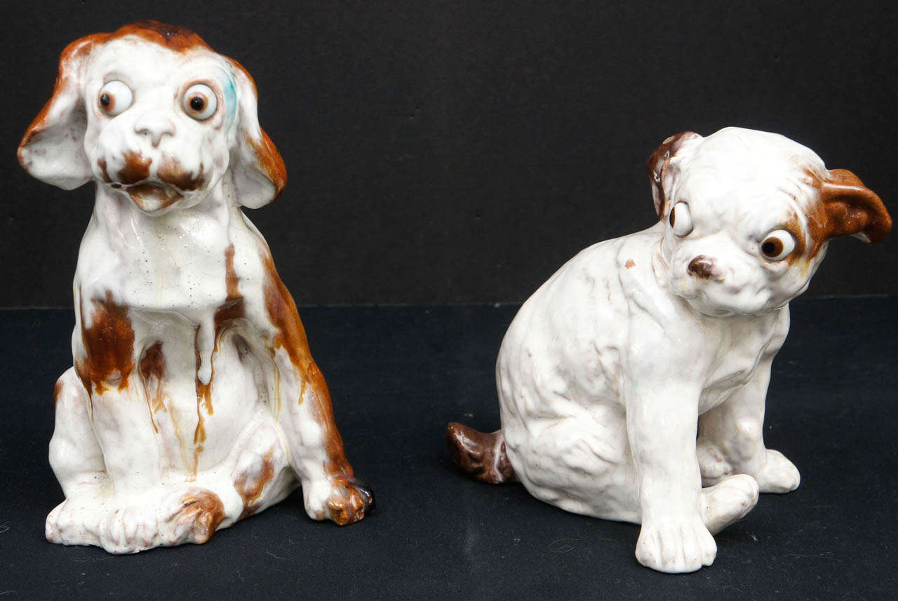 This  eccentric pair of dogs are from France. Indistinctly signed (Note Photo 10) on the base with the makers name and France the figures are clearly hand formed from heavy terra cotta then glazed with a lustrous spotty running glaze and finished