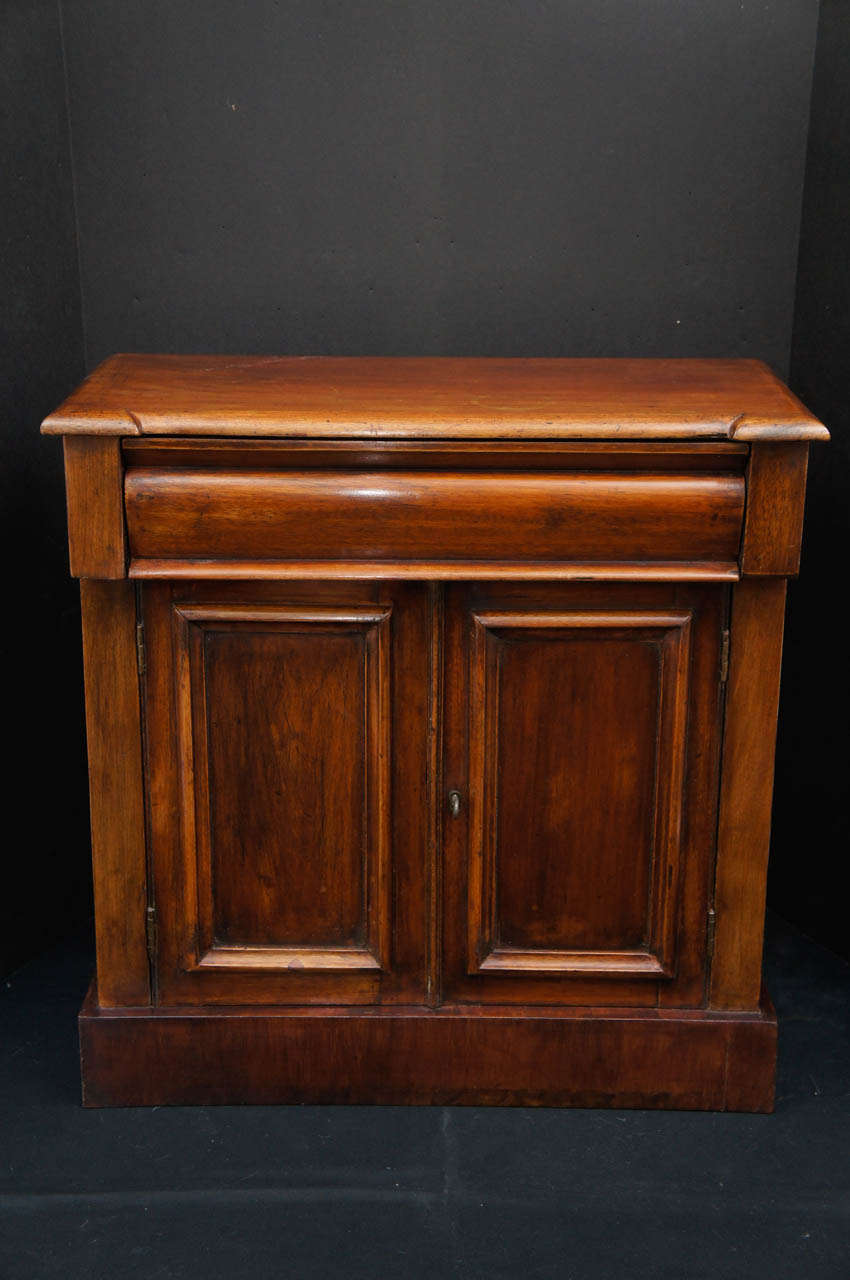 This well formed cabinet  circa 1870 was made either as a child's toy or salesman's sample cabinet and is of mahogany. The form and proportion are directly scaled to full size pieces and is made in total as an exact copy but reduced in size of a