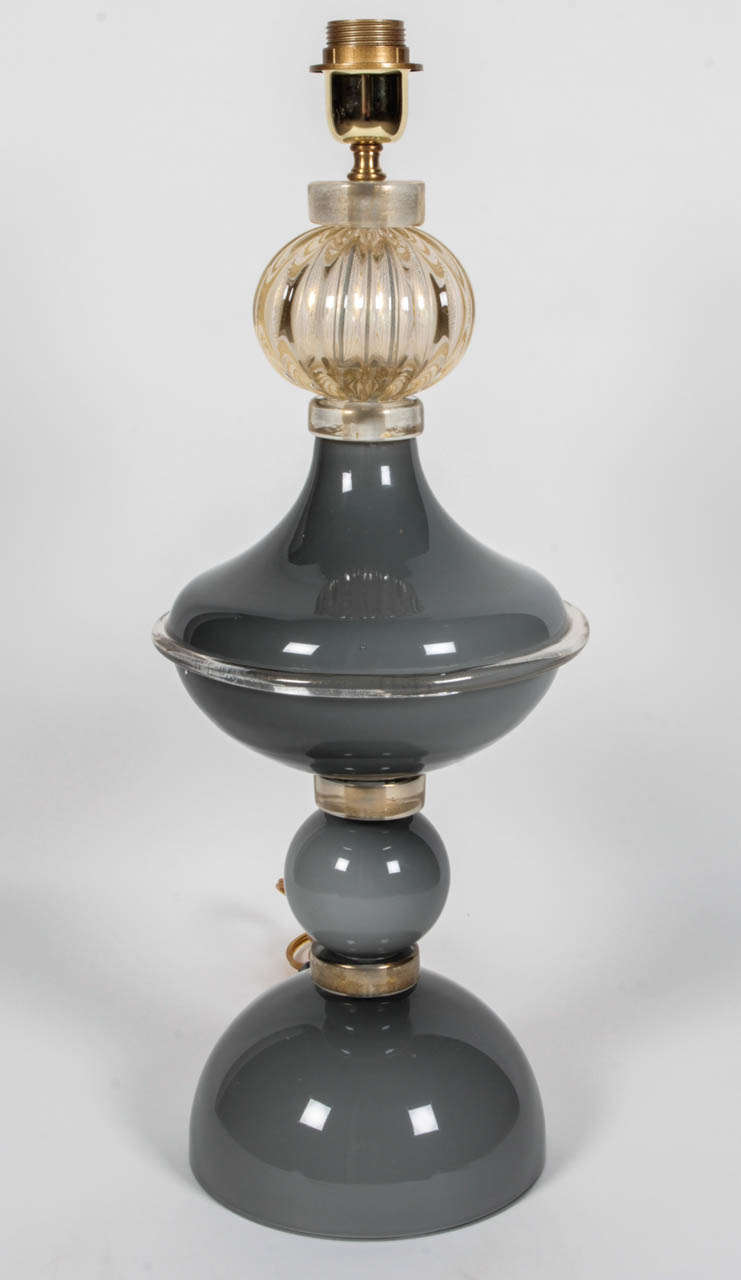 Very unique and classic, this pair of lamps were handblown in a solid grey tone Gold glass rings separate each of the grey toned glass globes and a single gold  ridged glass globe adds the finishing touch. Absolutely exquisite. Wired for U.S. These