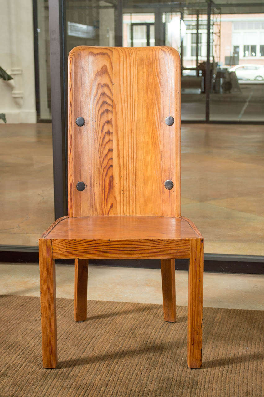 A rare set of dining chairs by Axel Einar Hjorth. Tall smooth backs with large black iron nails. Oregon pine with lovely grain and matte finish. Newly Restored.