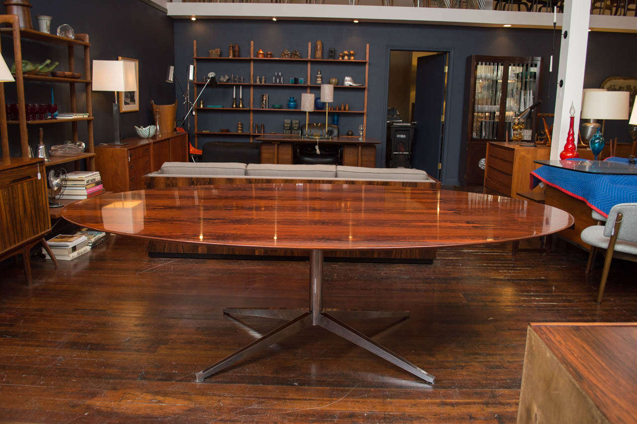 Rare large size of the rosewood oval dining table on a chrome splayed leg base, labeled.
 Completely refinished.