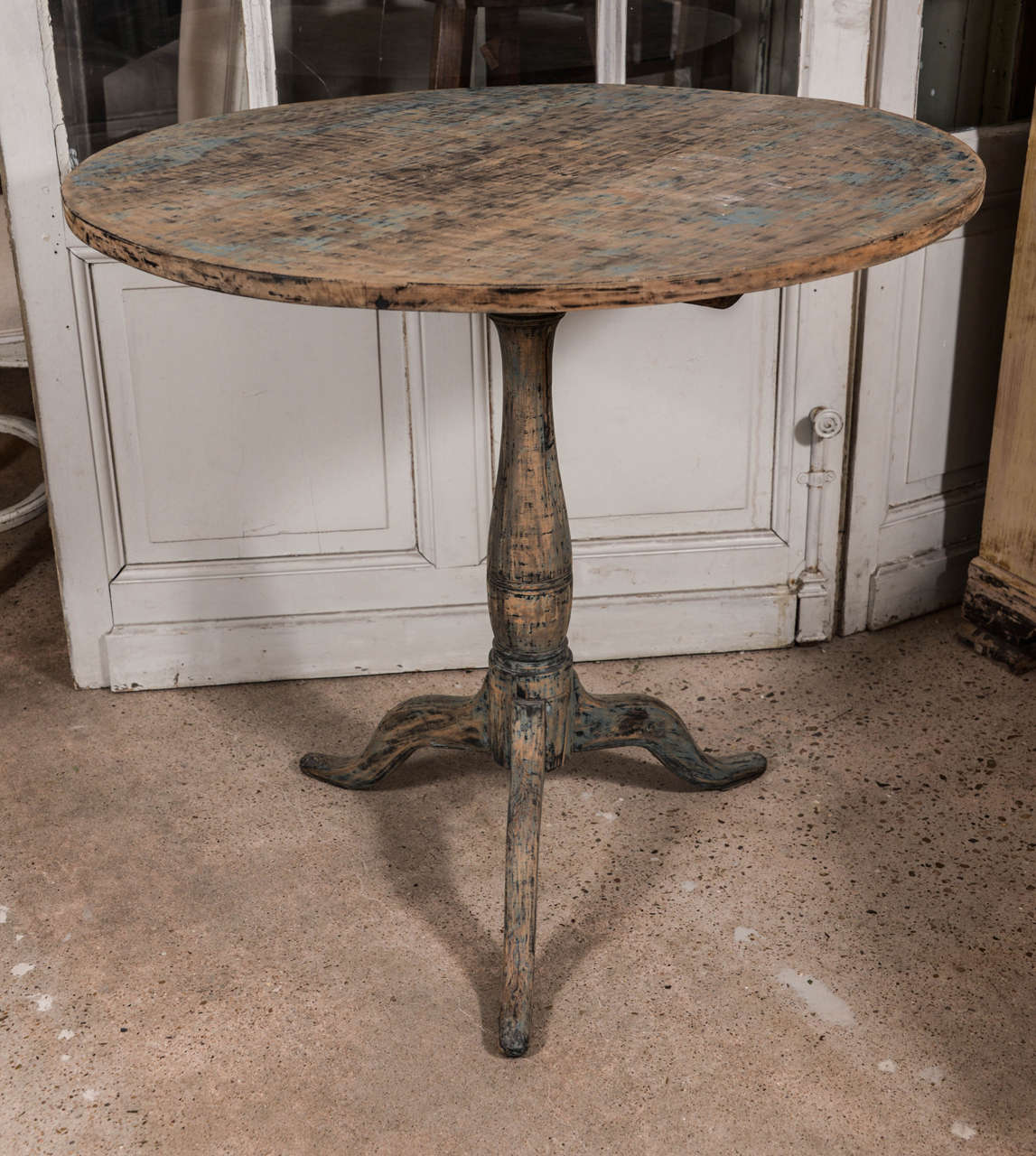 19th century tilt-top pedestal table with remnants of original blue and black paint.