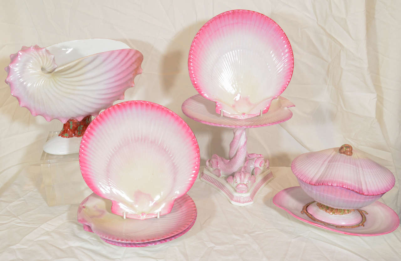 A 19th century Wedgwood neoclassical dessert service painted in a fanciful bright pink with naturalistically modeled shell shaped dishes, a nautilus shell for the centerpiece, a clam shell sauce tureen, an oyster shell for the dozen dessert dishes,