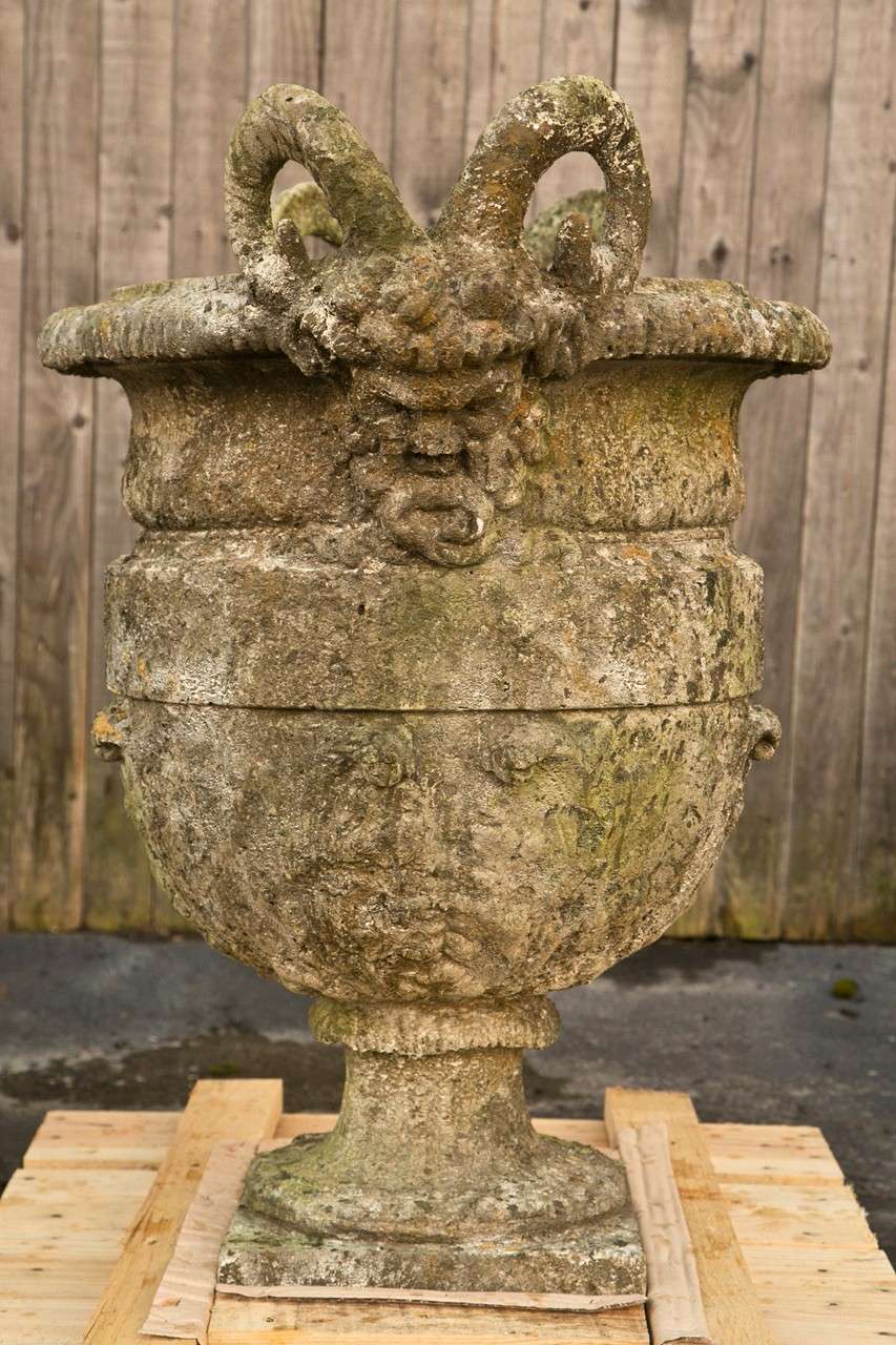 Set of four cement ram head urns in the classical design