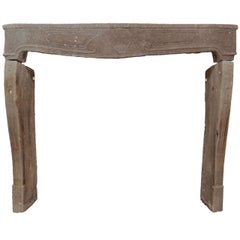 An early 18th c. French Baroque carved volcanic stone fireplace / mantel piece