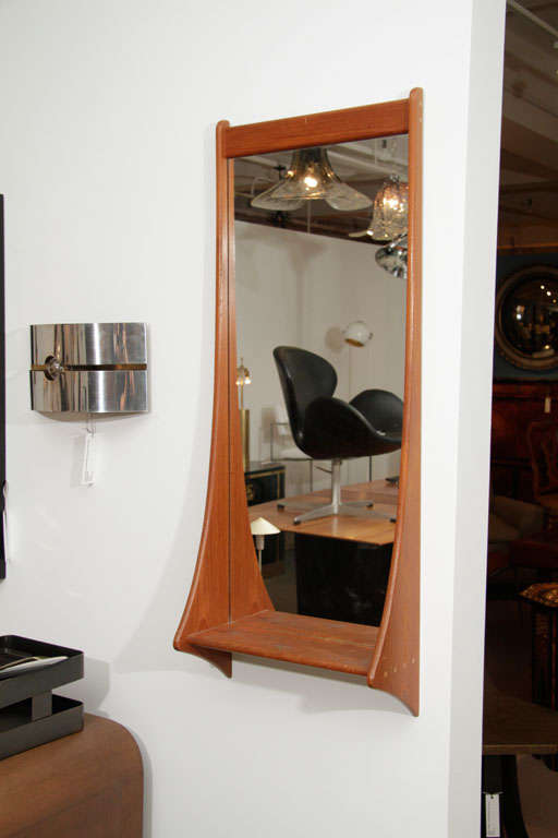 Teak wall mirror with shelf.  Denmark, circa 1960.  Beautifully joinery detailing.  Signed with maker's stamp on back.