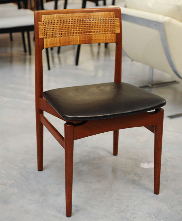 Set of two armchairs and four side chairs with teak frame. Back with cane, seat upholstered with original black leather. Made by cabintmaker Henrik Wørts