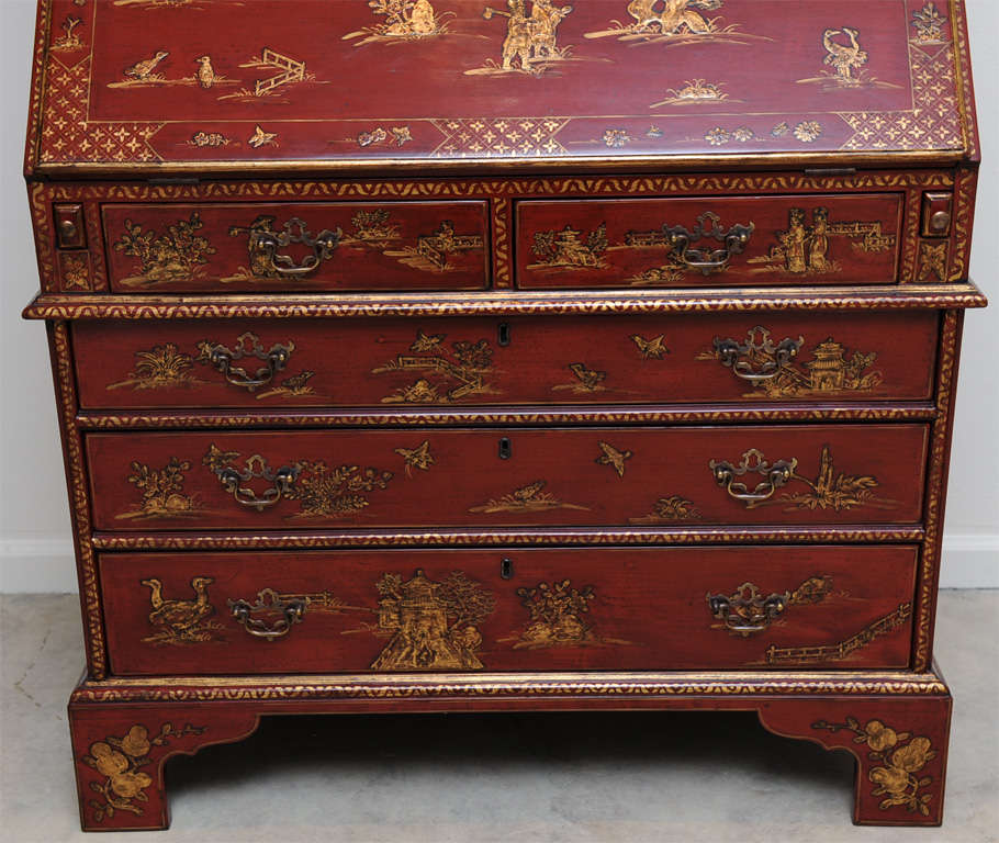 A George I style parcel gilt scarlet lacquered secretary bookcase; overall Chinoiserie decorated w/figures in exotic gardens