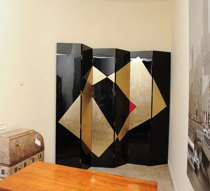 A 6-panel art deco style lacquered screen in gold, black and red,
