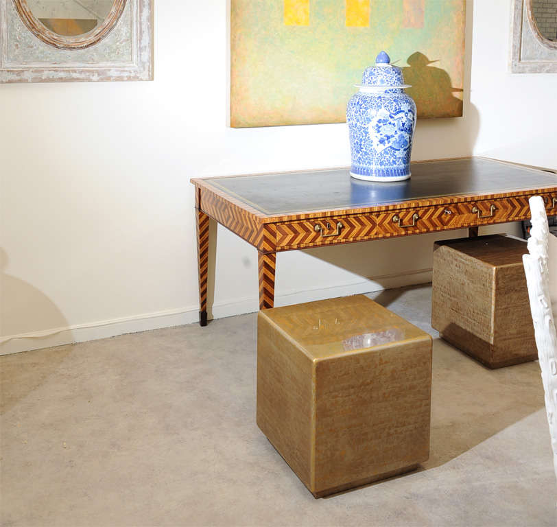 A pair of cube tables with a highly lacquered gold finish