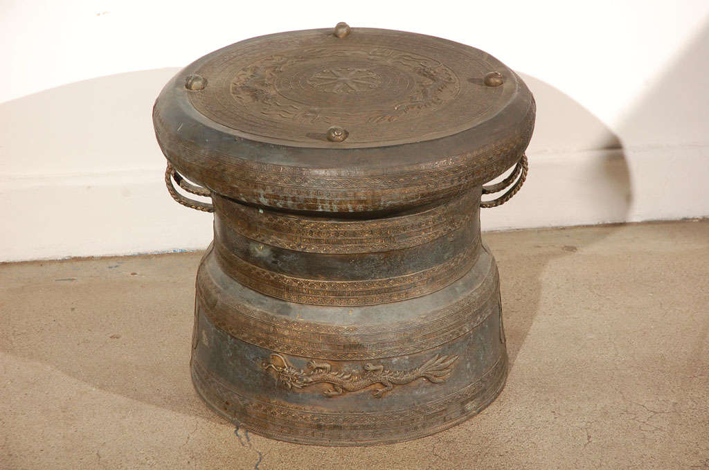 Asian Cast bronze rain drum with the traditional intricate detailing and patterns carved all around both the body and the top,the top is flat centered with a raised star surrounded by concentric geometric patterned bands and with raised nails. The