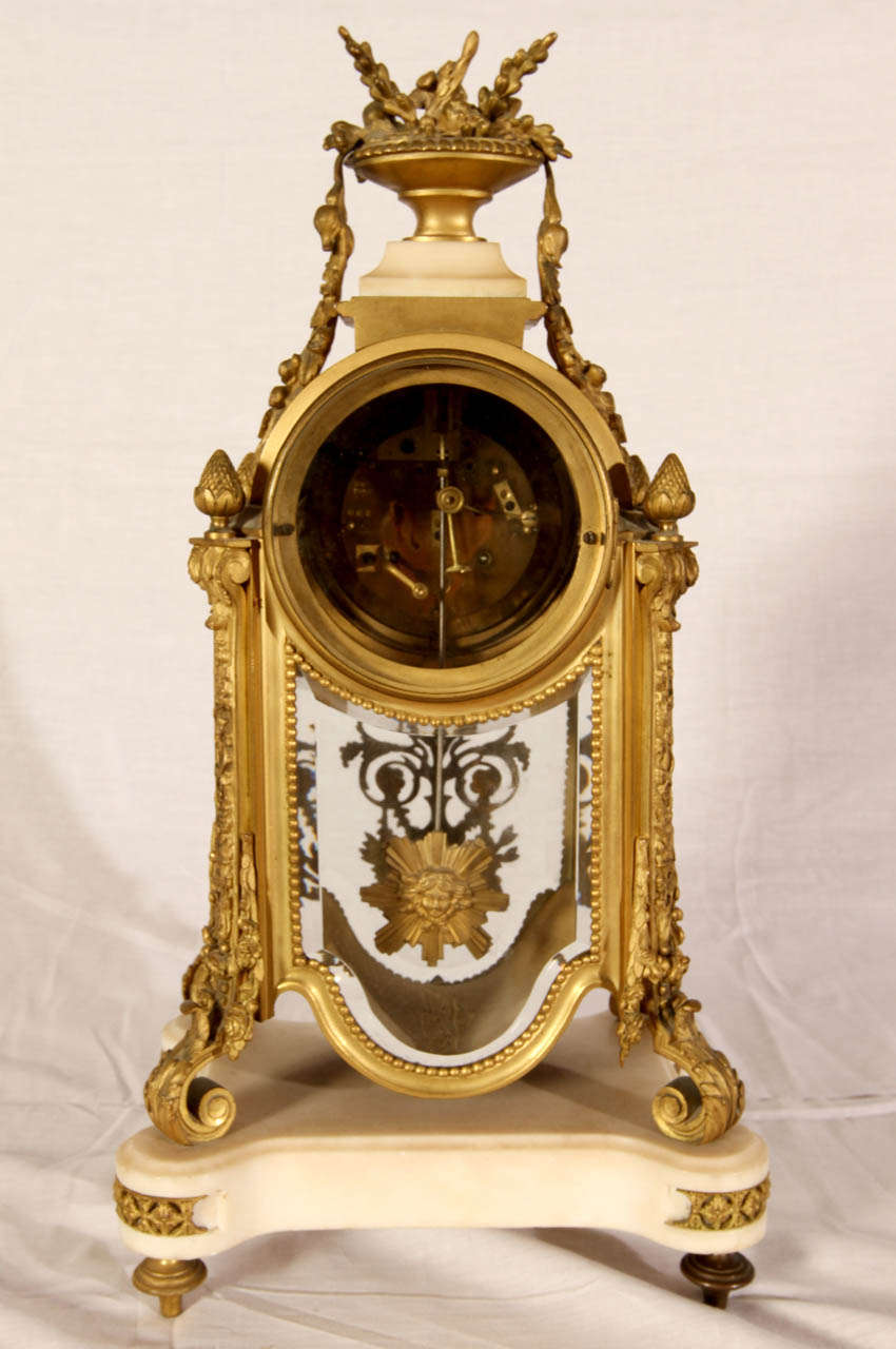 19th Century clock by Francois Linke. Gilded brass, white marble and beveled glass. Clock pendulum with Louis XVI effigy. Good condition. Normal wear consistent with age and use.