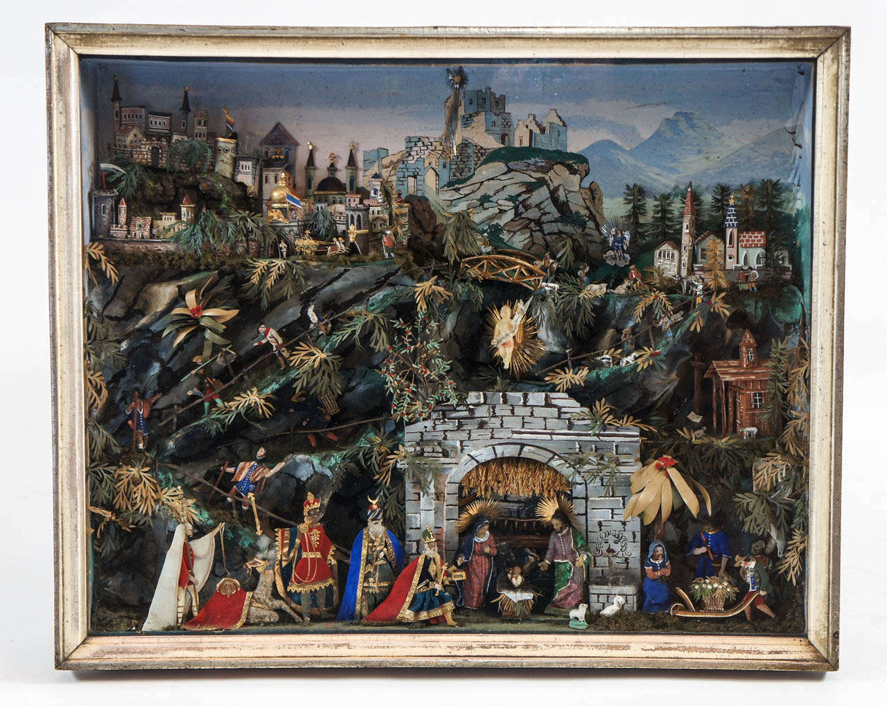 Extraordinary Swiss German creche diorama composed of intricately cut paper, cardboard, wood, and wax figures, greenery, and buildings with realistic painted Alpine scenic background.  Dated on reverse 23 December, 1887 in German.  Exceptional and