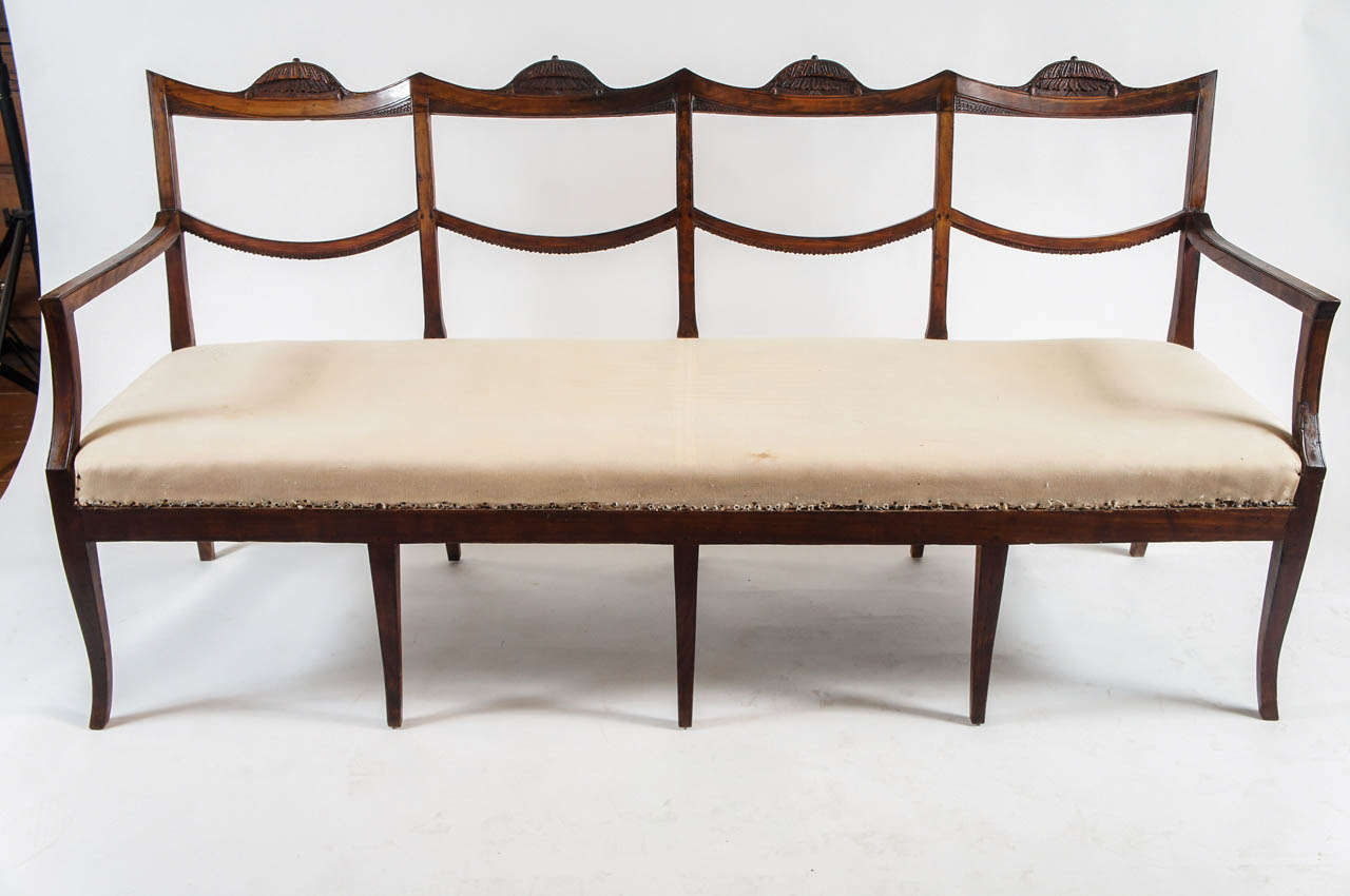 Elegant, c. 1810 Italian chinoiserie influenced suite of six chairs and four-seat settee all having foliate and scale-motif carved crest and back rails on gently splayed front legs.  Rare to find a set with matching settee.  Would be wonderful used