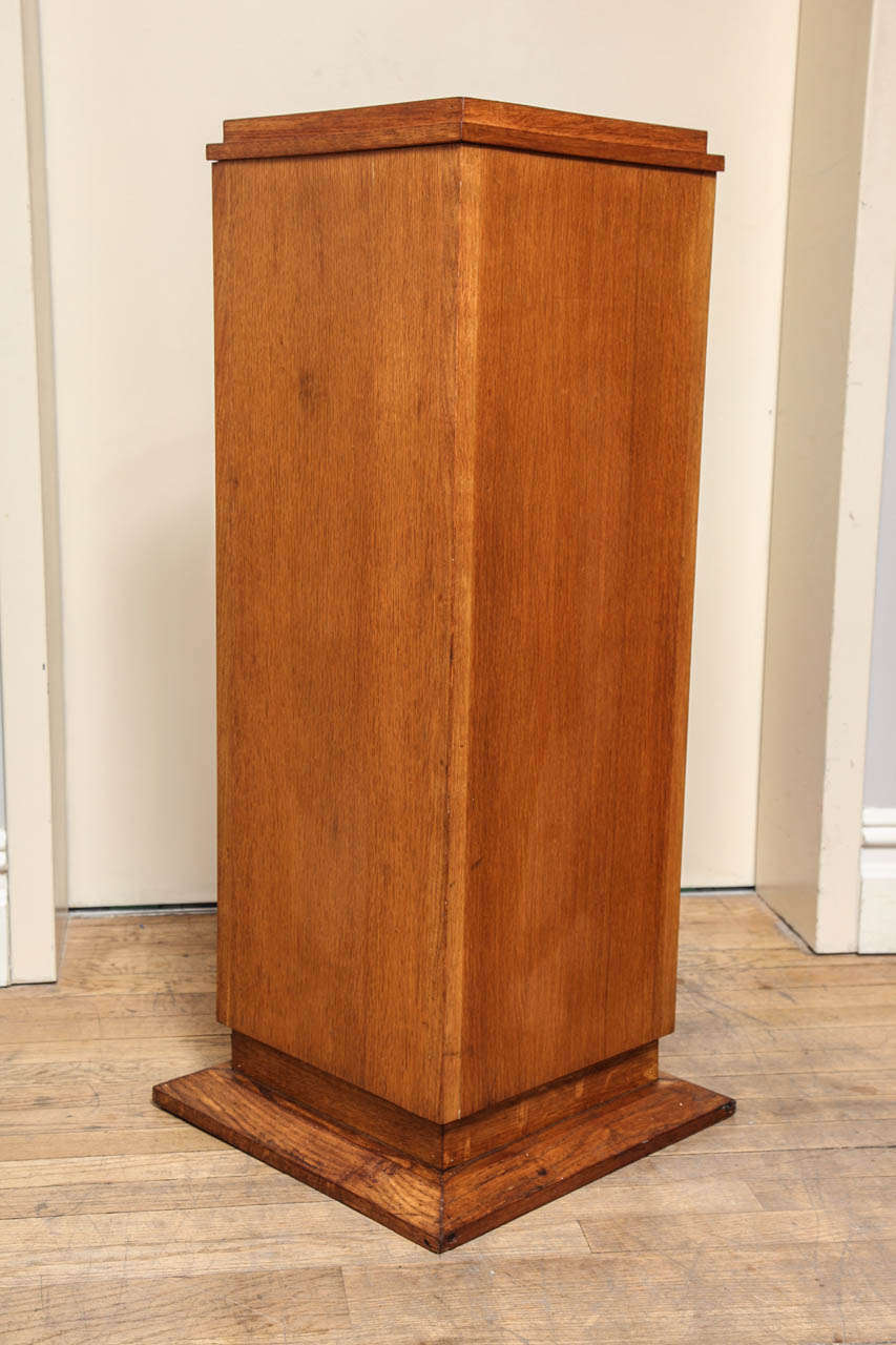 A French Art Deco square pedestal with fine oak veneered sides supported by stepped base.