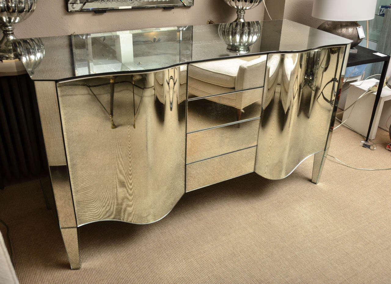 Magnificent Italian mirrored sideboard/dry bar. All mirrored surfaces are beveled and the back is mirrored. The doors have curved glass.