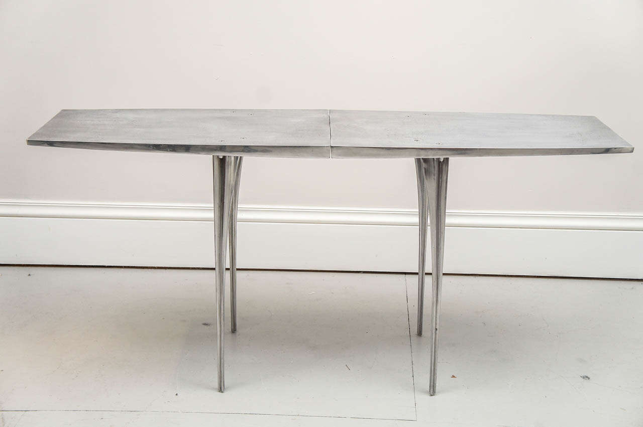 A striking console table with polished aluminum legs and sand cast unpolished aluminum top designed by Robert 