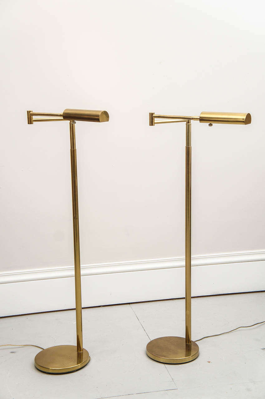 Classic pair of Koch and Lowy brass floor lamps. Adjustable height and swing arm.
