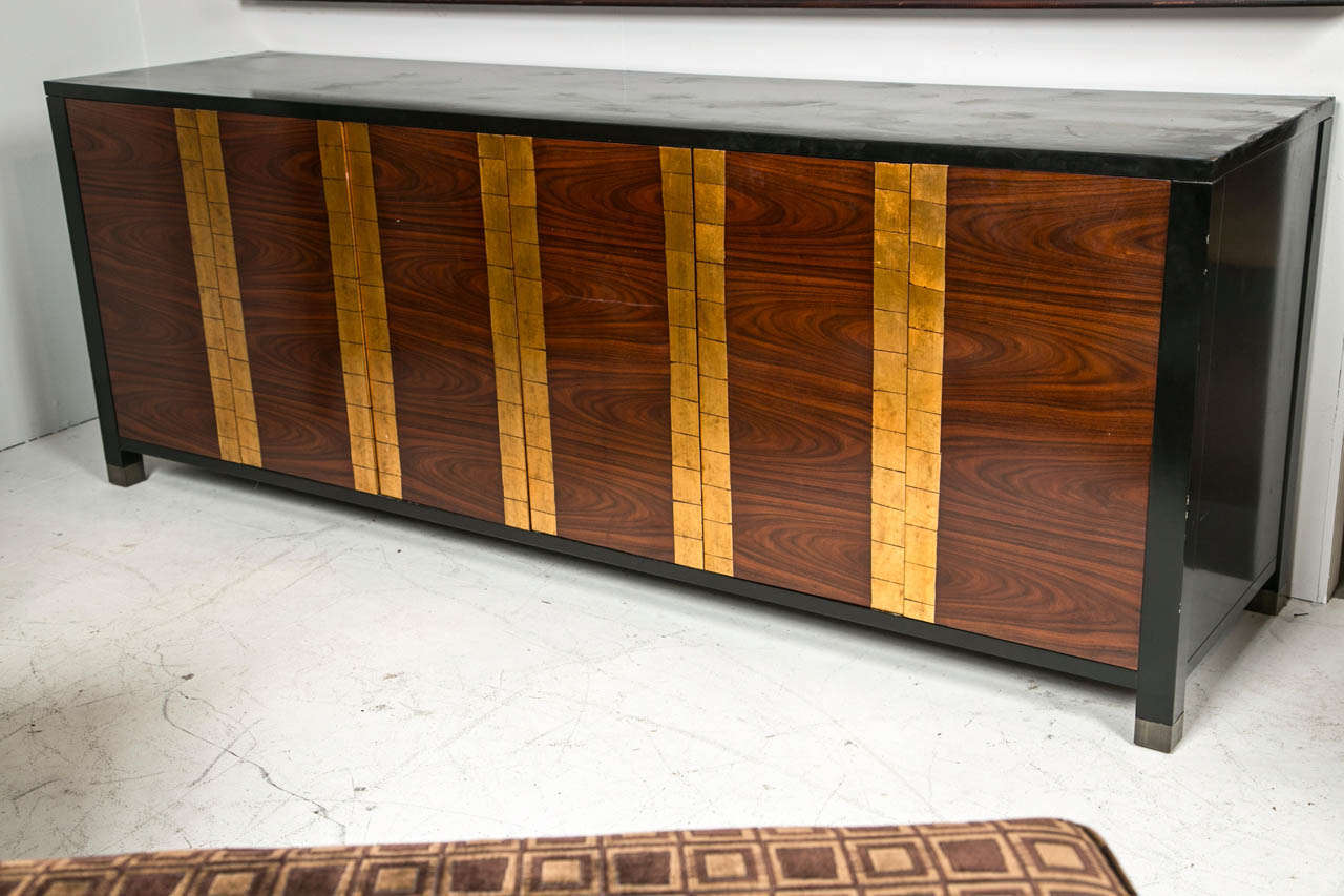A wonderful Bolier entertainment cabinet. Gold leaf on flame mahogany Top and side lacquered black.