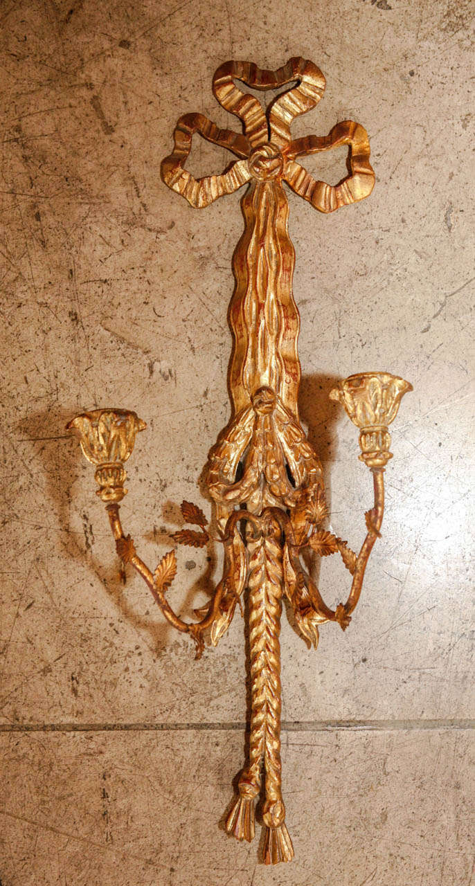 A decorative pair of gold leaf ribbon, rope and tassel wall mounted sconces (not electrified). Has vintage 