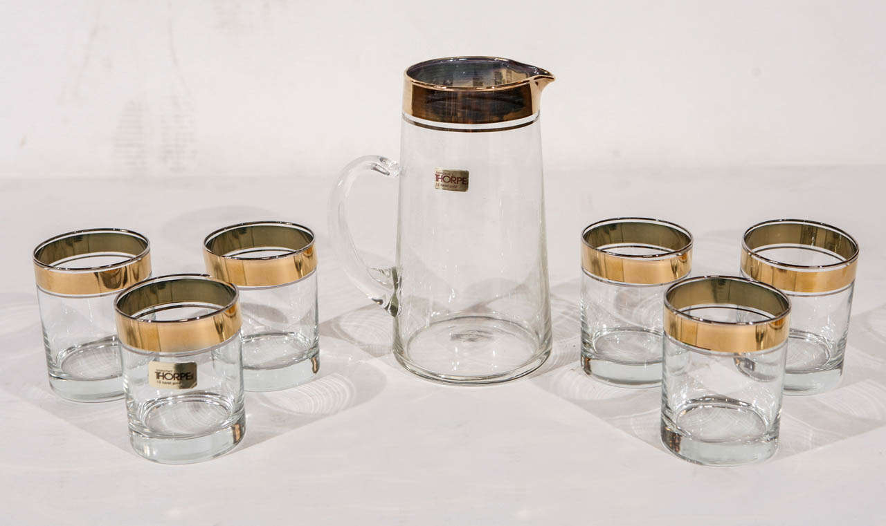 A vintage set of glassware (pitcher and 6 glasses) by Dorothy Thorpe. Decorated with 22k gold banding. Pitcher and one glass still has the Dorothy C. Thorpe original labels.

Pitcher is 6 1/2