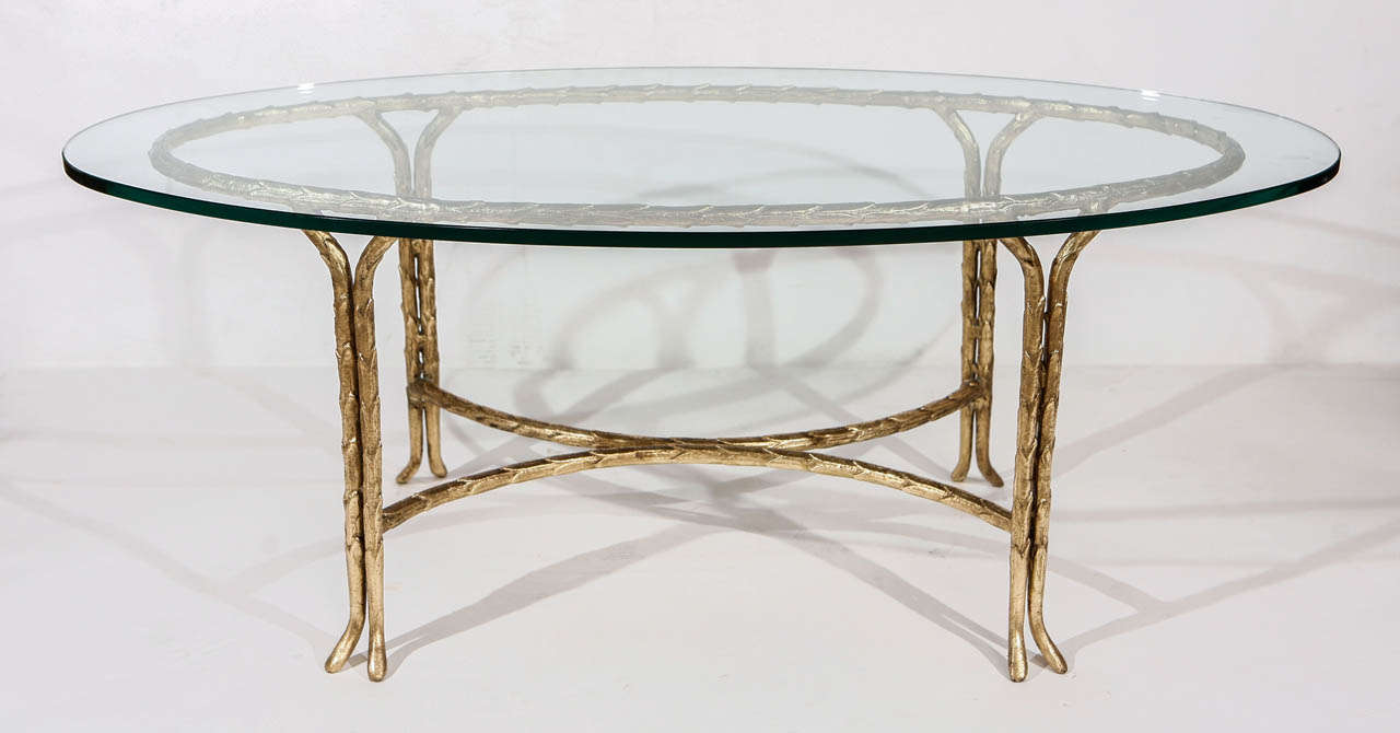 An amazing Maison Bagues gold leafed coffee table with a leaf design. Base (without glass) measures 37