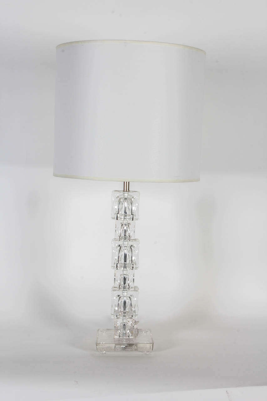 Fantastic pair of stacked crystal block lamps with concave sides and resting on a crystal base.