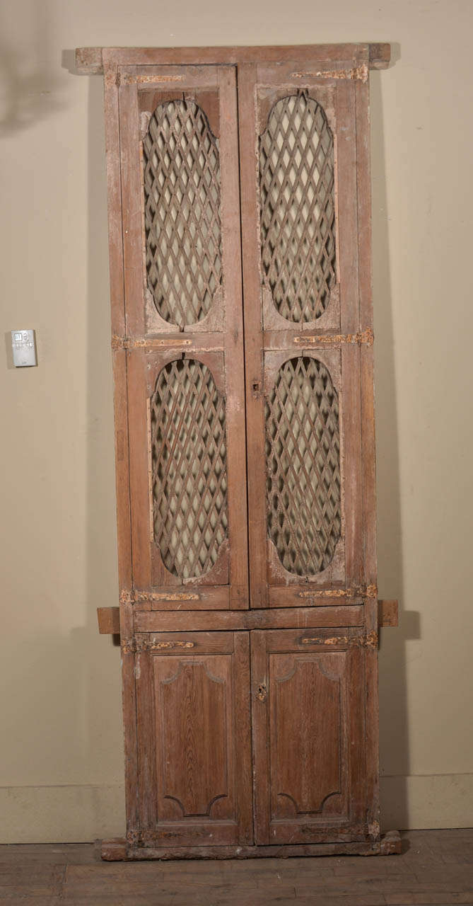 Late 18th century doors: upper wood lattice work panel doors and lower solid carved panel doors. Ideal for pantry doors!