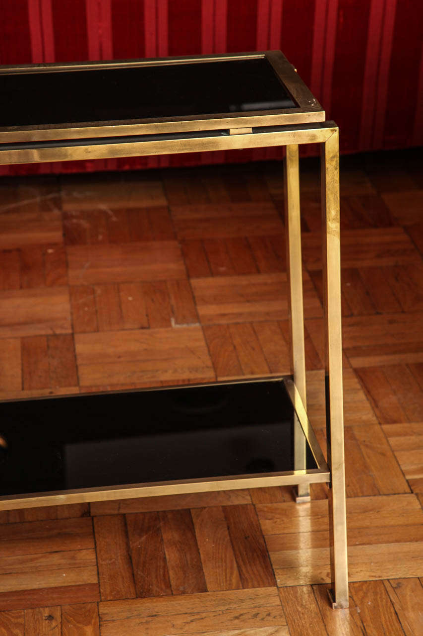 A Two-Tier Brass and Black Glass Console Table, France c. 1970 In Excellent Condition In New York, NY