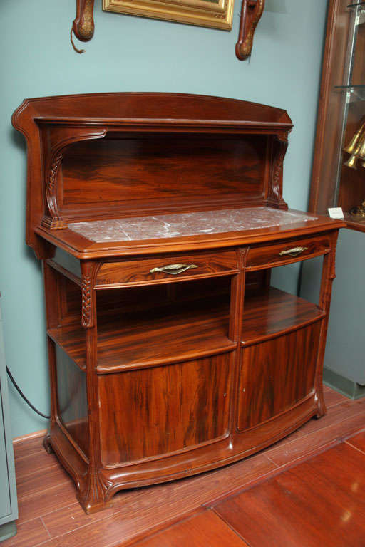 A French Art Nouveau carved mahogany and rosewood 