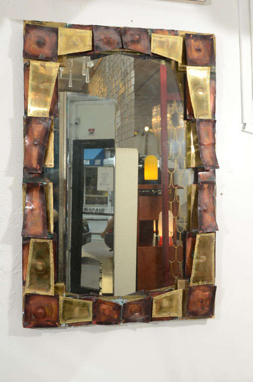 

Nicely produced mirror with a sculptural frame of torch cut pieces of patinated brass and copper. Please contact for location.