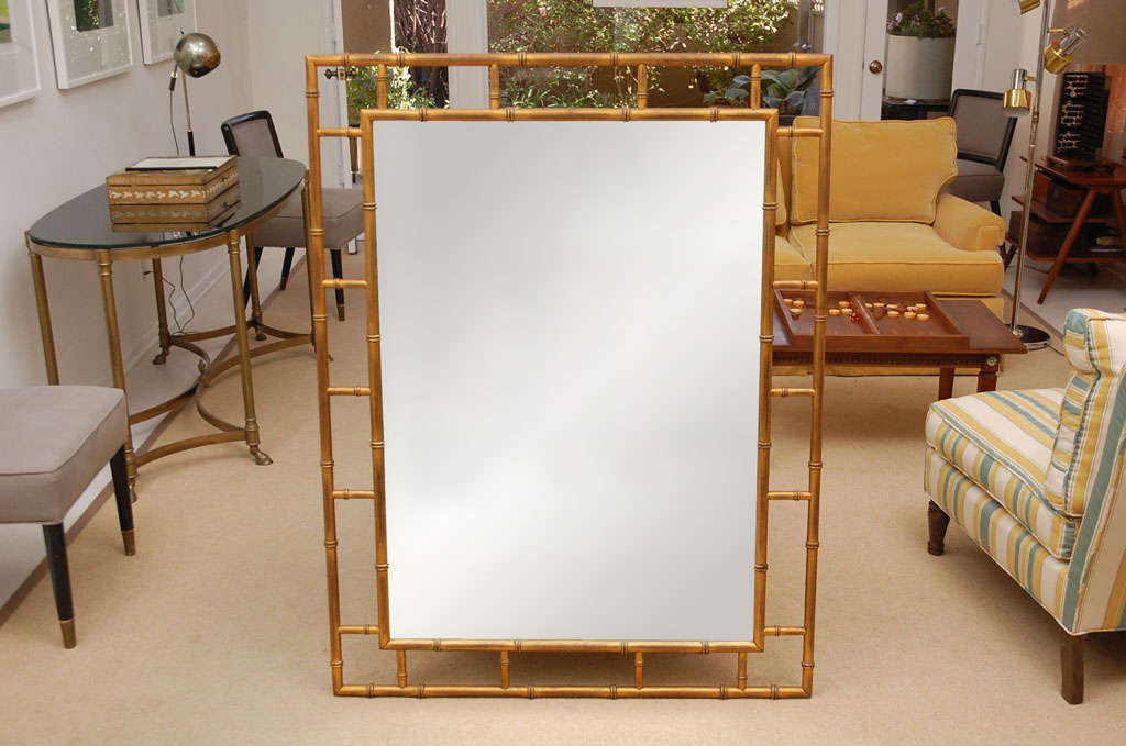 This elegant and timeless rubbed gold faux bamboo mirror adds glamor and style to any room.