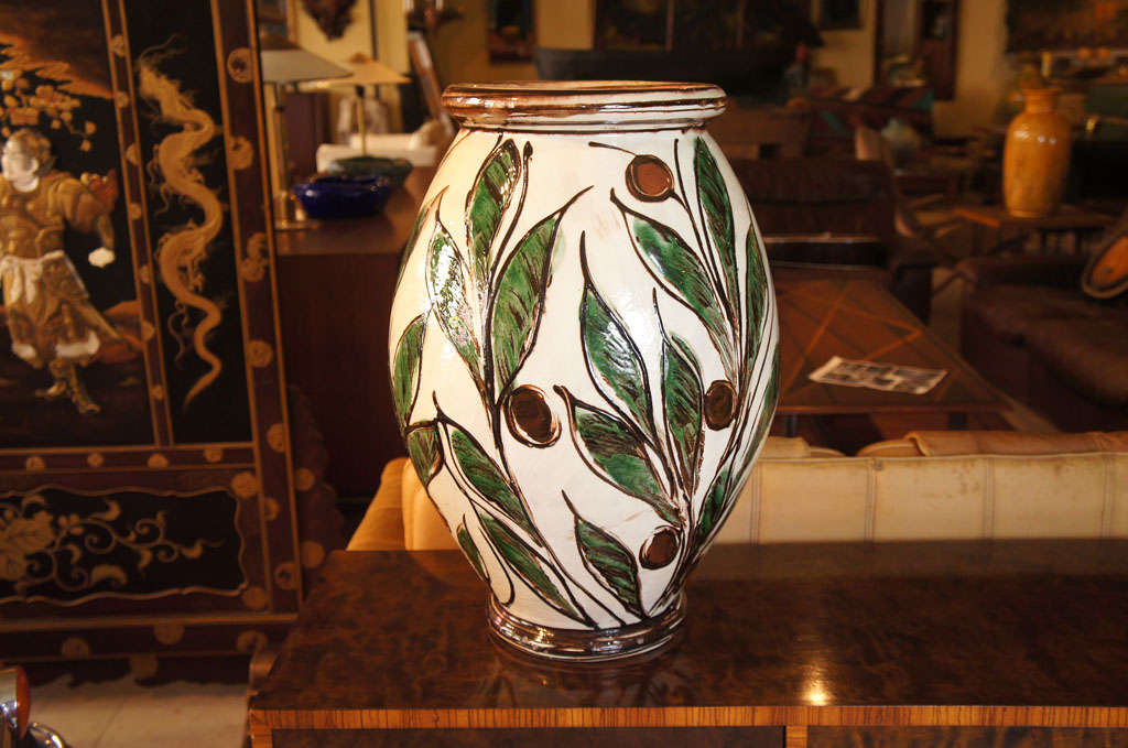 Large vase from Kahler Keramic in Naestved, Denmark decorated with green leaves and dark red fruit, likely by Julia Kabel using the Horn painted technique.