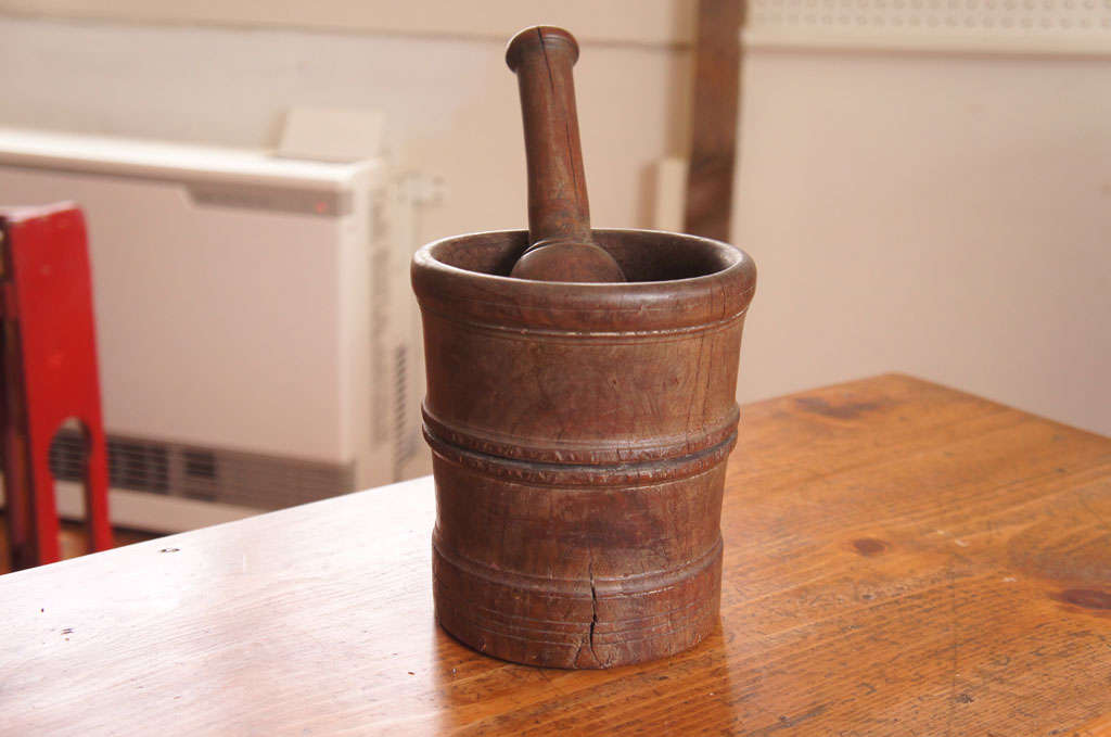 this American Mortar and Pestle  were traditionally used in a pharmacy to grind solid objects. this piece is in very nice condition and we see it as a decorative piece in your home. it would look terfific in a kitchen.