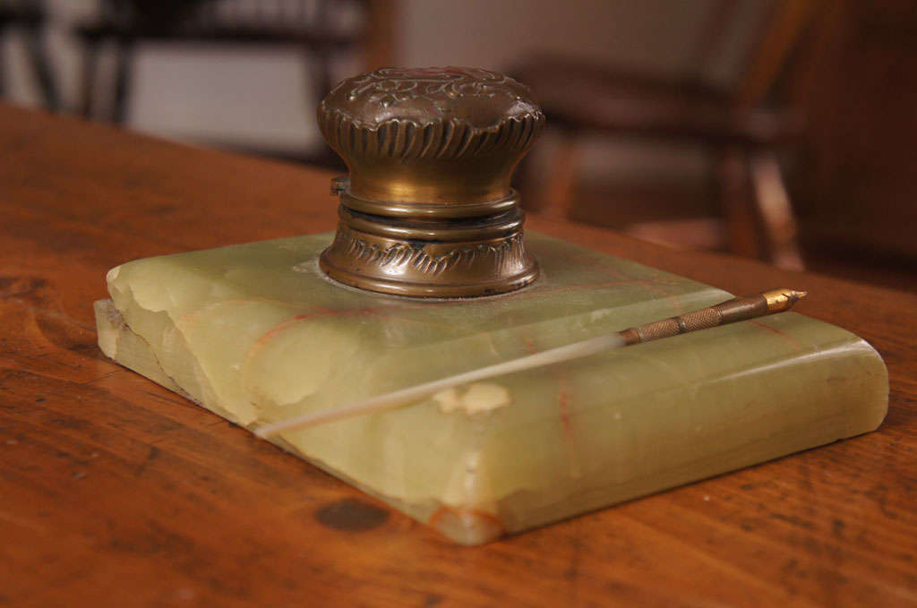 This Inkwell dates to 1890 and is usable , with a mother of Pearl handle. There are a few small damages on the front corner and back, but it is a stunning piece with both a workable pen and inkwell. it would be a perfect display piece for your desk!