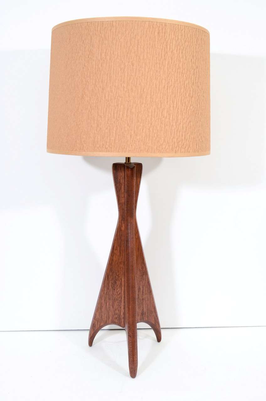 A single vintage table lamp with tripod base body of carved wood. The piece is in good vintage condition with age appropriate wear; some scratches

Reduced from $550.00