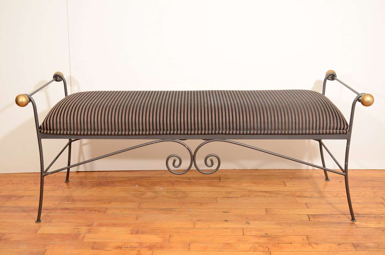 A vintage bench with an enameled iron frame an striped upholstery. The piece is in good vintage condition with age appropriate wear; some loss of enamel and a spot on upholstery.

Price reduced from $1650.00