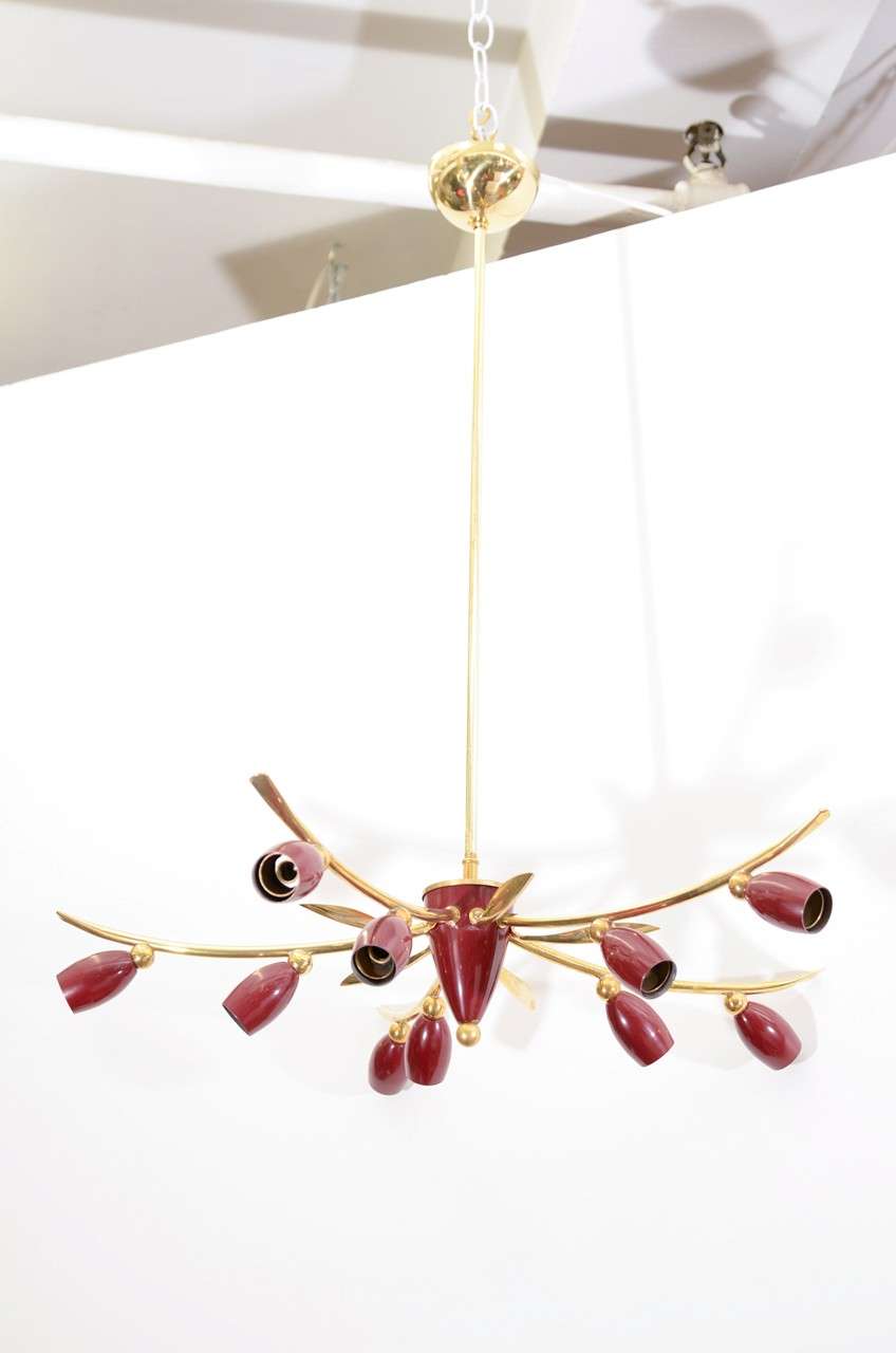 A vintage German chandelier with five arms and ten lights. The arms are in brass while the central hub and the light sockets are in deep red enamel. 

Please note that this fixture requires E14 130 volt bulbs